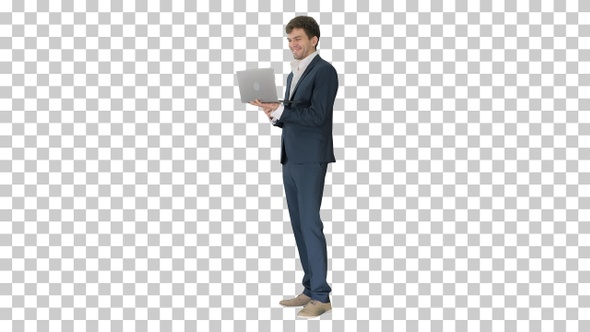 Smiling young businessman using laptop, Alpha Channel