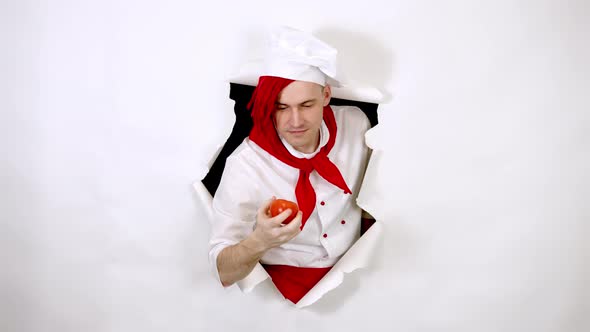 Young Handsome Man Dressed As Chef with Red Tomato