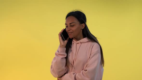 Pretty African Lady Getting Amazing News From Friend While Speaking By Smartphone.