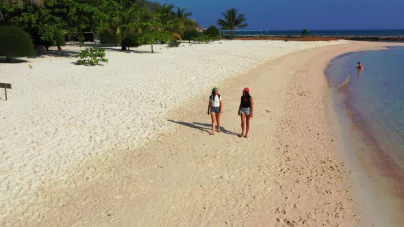 Women tan on perfect tourist beach trip by blue sea and white sand background of Thailand near sandb