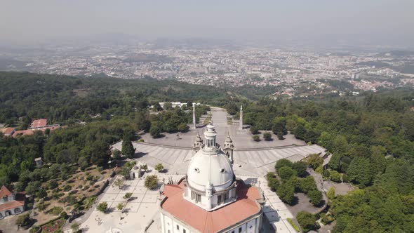 Aerial pullback of the Sanctuary of Sameiro against Braga sprawling cityscape.