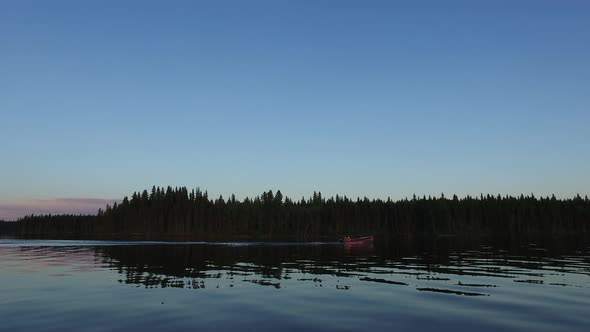 Motorboat sailing on lake at dusk