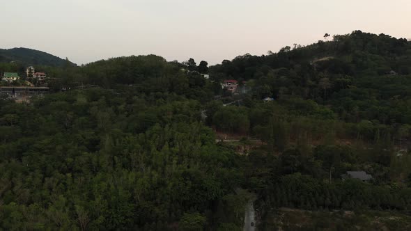 Drone Flight Over the Jungle and Sea City After Sunset