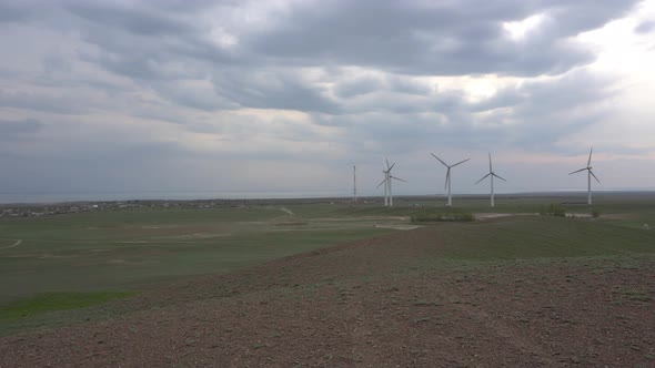 Windmills in the Steppe on the Lake Shore