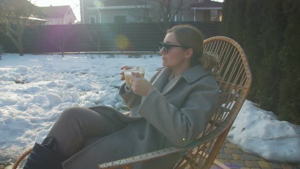 Woman Drinking Coffee Yard