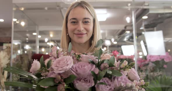 Smiling Florist Showing Off Her Bouquet. Portrait. Small Business Owner