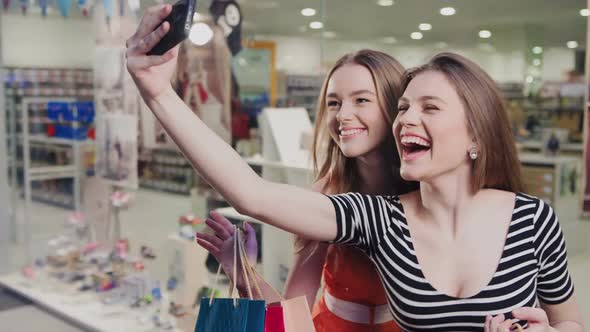 Two Happy Friends Is Taking Selfie While Shopping in Mall