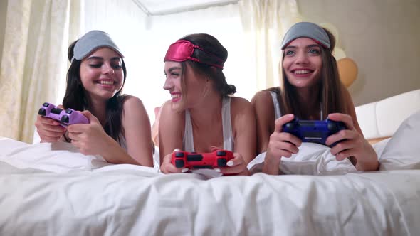 Girls Playing with Video Game with Joystick.