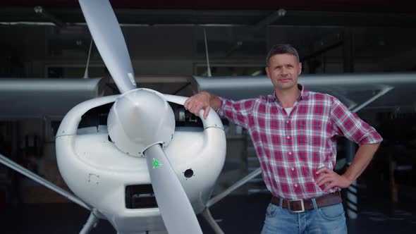 Pilot Airplane Posing Standing Hangar Leaning on Aircraft Body Close Up