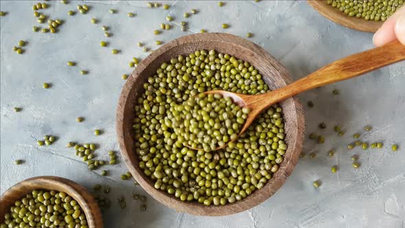 Dried mung beans on a plate with a spoon top view