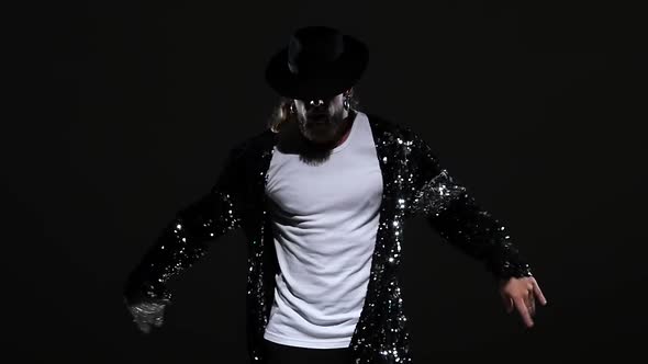 Young Stylish Man Dancing in Style Michael Jackson, Spotlight on a Black Background