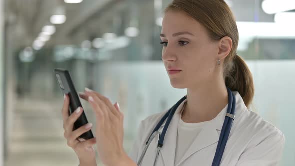 Portrait of Attractive Female Doctor Using Smartphone 