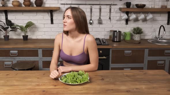 A Personal Trainer Yells Into a Megaphone Making the Girl Eat Salad