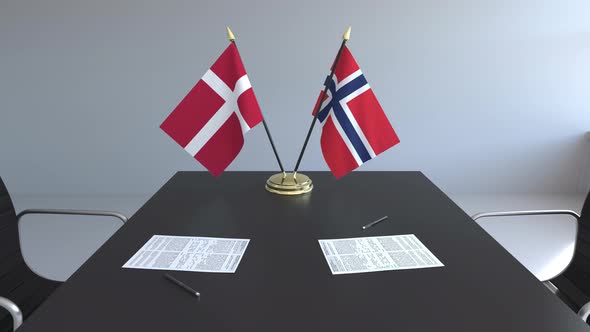 Flags of Denmark and Norway and Papers on the Table