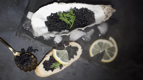 Black Caviar Is Served on a Plate in the Form of a Real Shell with Mother of Pearl. The Concept of
