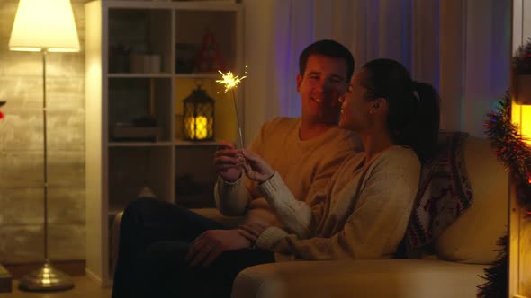 Cheerful Husband and His Wife Playing with Fireworks