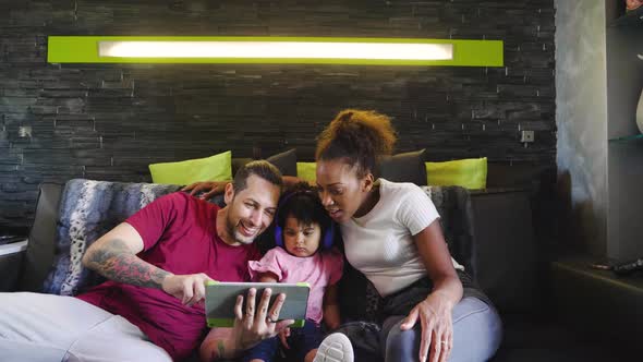 Family using tablet on sofa