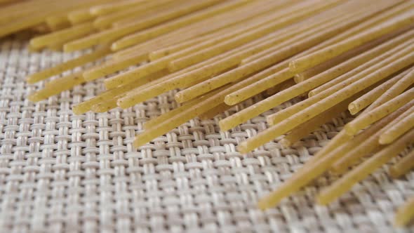 Close-up detailed integral raw spaghetti stacked on a kitchen napkin