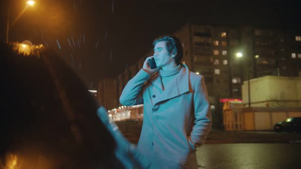 Handsome Young Man Talking on the Phone Outdoors