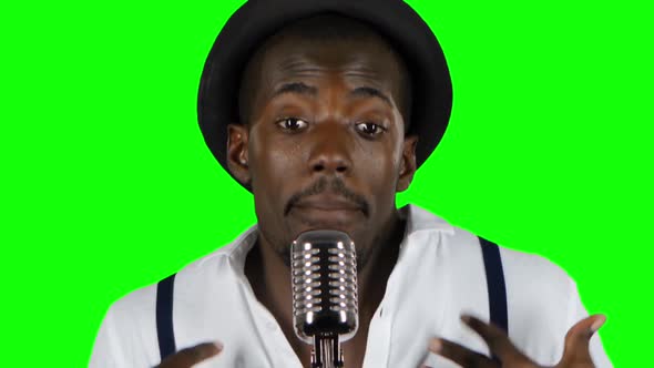 Guy with a Mustache and Beard Sings Into a Retro Microphone. Green Screen. Close Up