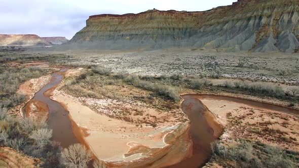 Aerial view of winding river flowing through the red Utah desert