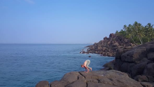 Slim Woman Practices Yoga Position Against Tropical Nature