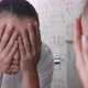 Young Woman is Washing Her Face in Front of the Mirror in Bathroom - VideoHive Item for Sale