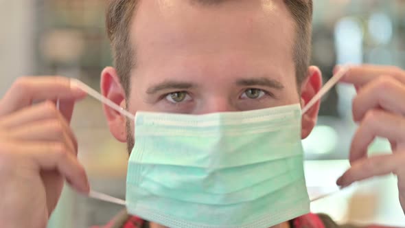 Close Up of Young Man Wearing Protective Face Mask 