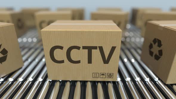 Cartons with CCTV Equipment on Roller Conveyors