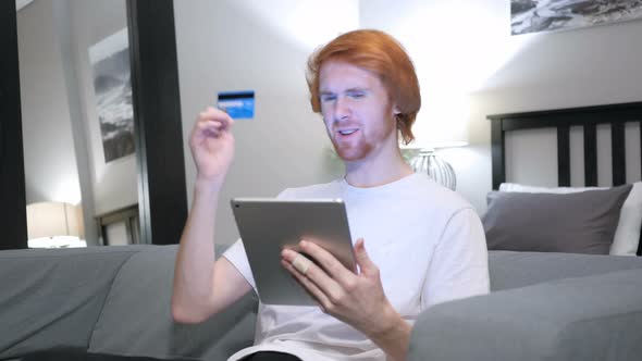 Fail Online Shopping on Tablet by Casual Redhead Man