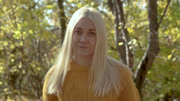 Portrait of a beautiful young woman in autumn forest.