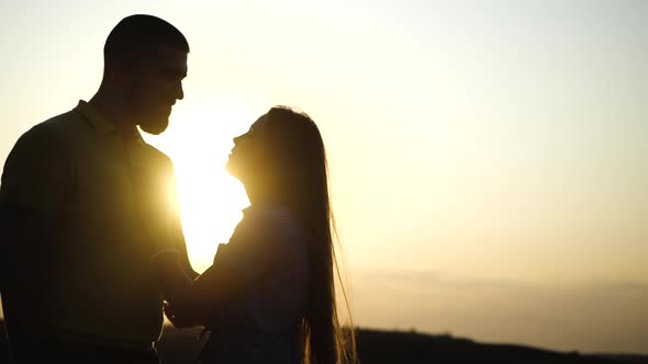 Beautiful Girl Strokes Face of Bearded Guy and They Rub Noses in Slow Motion Close Up, Sunset Shines