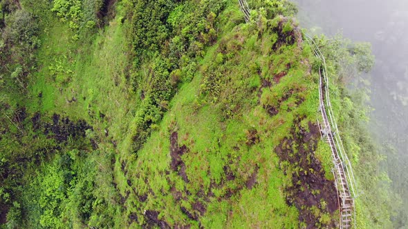 Aerial view of Stairway to Heaven (Haiku Stairs) in Hawaii with stairway on a cliff disappearing int