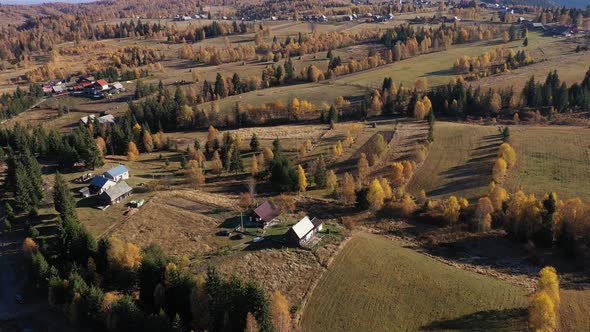 Flying Above Rural Countryside Landscape. Homestead and Village in the Autumn