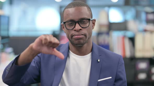 Portrait of Thumbs Down Gesture By African Businessman