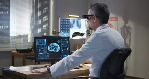 Doctor Analyzing Brain Scan with VR Technology