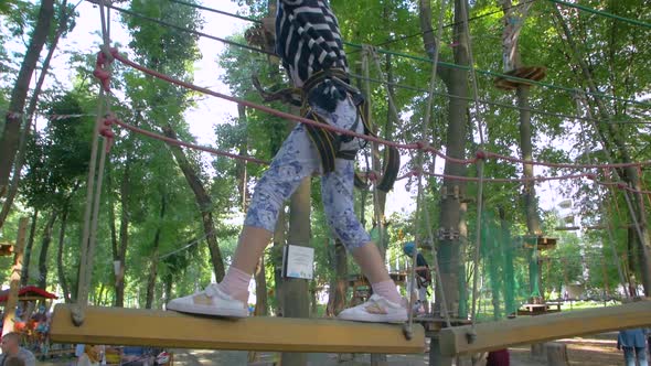 Little Girl On Rope Bridge