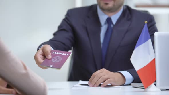 French Consular Officer Giving Passport to Woman, Refugee Visa, Asylum Status