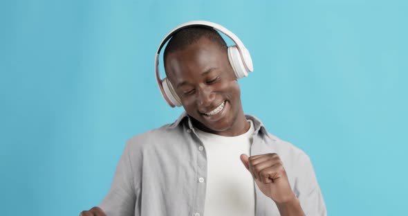 Emotional African American Guy Listening To Music in Headphones