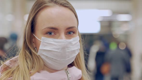 European Woman in Protective Disposable Medical Mask in Metro. Concept Protection of Dangerous 2019