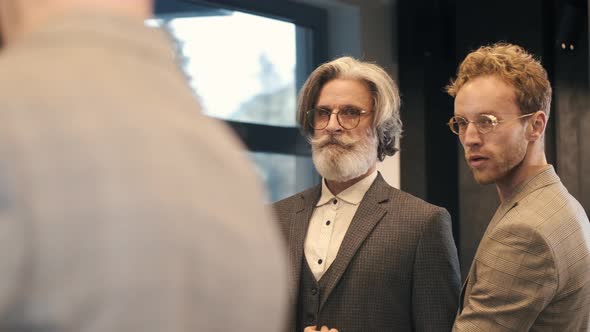 Man Trying Business Suit on with Consultant at Men Clothing Store