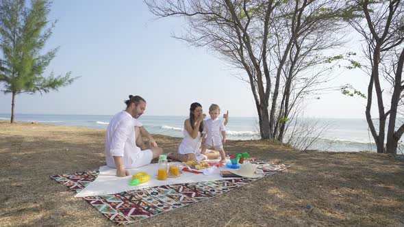 4K Happy Caucasian family picnic together on tropical beach.