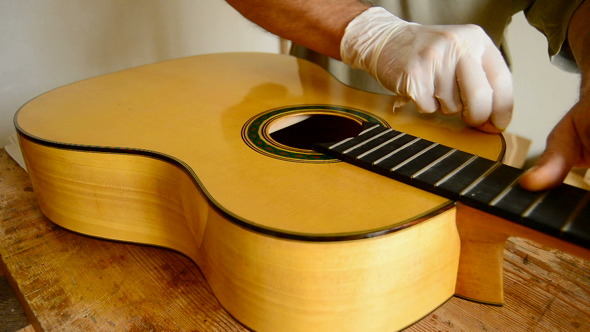 Luthier Varnishing Guitar