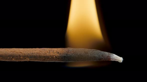 Incense Stick with Smoke on Black Background