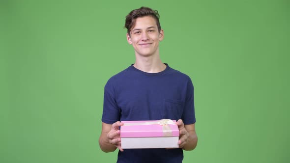 Young Handsome Teenage Boy with Gift Box