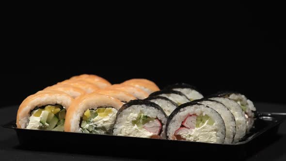 Sushi Rolls Rotates Plastic Container Black Background