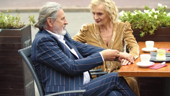 Elderly Couple Sitting at the Table