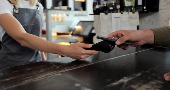 Close Up Male Customer Pays for Take Away Coffee with Contactless Nfc Payment Technology on