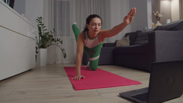 Slim Woman Developing Good Balance Posture Using Laptop at Home