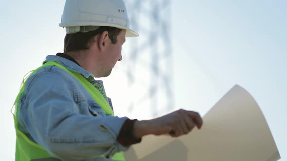 Architect Worker Checking Construction Project On Electric Tower